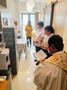 a group of people standing around in a kitchen at Fame Residences Tower-1 Unit 3207 in Mandaluyong 1 Br w Balcony City view in Manila