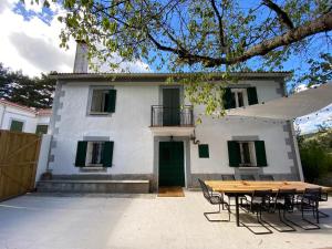 RobregordoBalagares_11的一间房子，前面有一张桌子和几把椅子