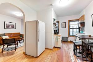a kitchen and a living room with a refrigerator at Delightful 2BR Apartment in NYC! in New York