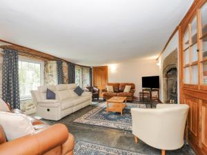 a living room with white furniture and a fireplace at Carneadon Farmhouse in Launceston