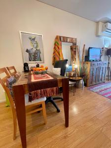 a living room with a wooden table and a desk at Palermo in Buenos Aires