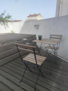 two benches and a table on a deck at Villette in Aubervilliers