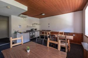 a kitchen and dining room with a table and chairs at Hostel Chillertal in Mayrhofen