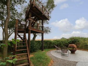 a tree house with two chairs and a staircase at The Stang Hideaway in Richmond