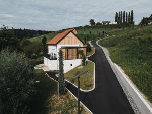 una casa en una colina al lado de una carretera en Das Dietrich - Landhaus 64, en Leibnitz