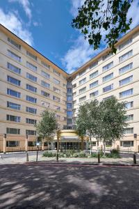 a large building with trees in front of it at Melia White House Hotel in London