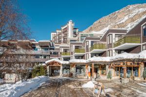 a hotel in the mountains with snow on the ground at Appartement CHEVRIL à l'Hôtel LE VAL D'ISERE in Val dʼIsère