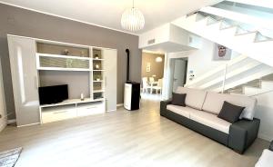 a living room with a couch and a television at Villa Cavagrande in Avola