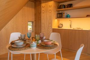 a dining room with a table and chairs at Cabaña de Xarás, Chuchamel in Ardán