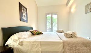 a bedroom with a large white bed with towels on it at Villa Cavagrande in Avola