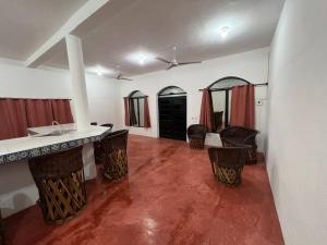 a room with a sink and some chairs in it at La Casa Blanca in Tecomán