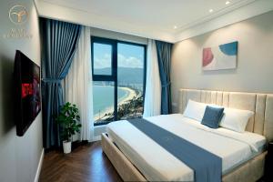 a bedroom with a bed and a large window at Armin Homes Altara Residences Quy Nhon in Quy Nhon