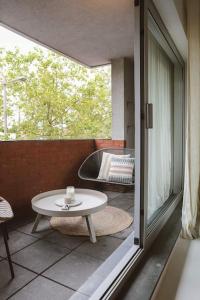 een kamer met een tafel en een bad op een balkon bij Appartement in Antwerpen in Antwerpen