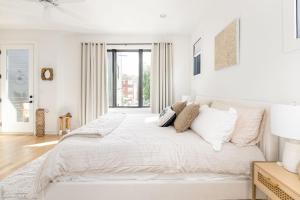 ナッシュビルにあるExtra Spacious 4 Bed / 4.5 Bath Music Row Homeの白いベッドルーム(大型ベッド1台、枕付)