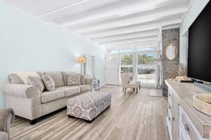 sala de estar con sofá y TV en Madeira Beach Retreat en St Pete Beach