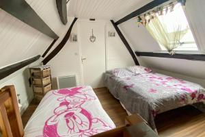 a bedroom with two beds in a attic at Gîte Etienne Marie in Le Crotoy