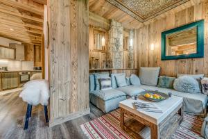 a living room with a couch and a table at Appartement FORNET à l'Hôtel LE VAL D'ISERE in Val dʼIsère +18 photos