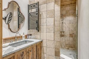 a bathroom with a sink and a shower at Appartement FORNET à l'Hôtel LE VAL D'ISERE in Val dʼIsère