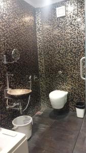a bathroom with a toilet and a sink at Zoom Inn Heritage in Puducherry