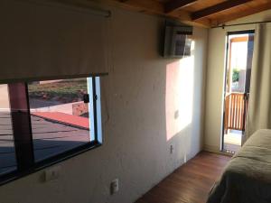 a room with a window with a view of a patio at Chalé vista da serra in Delfinópolis