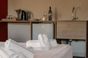 a kitchen with towels on a bed with a refrigerator at SEITAN PAZAR (Olive/Akrokeramos) in Preveza +45 photos