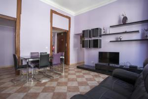 a living room with a table and chairs and a fireplace at FLH Baixa Comfortable Apartment in Lisbon