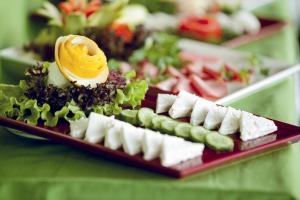 a plate of food with cheese and vegetables on a table at Golden Pen Hotel in Istanbul