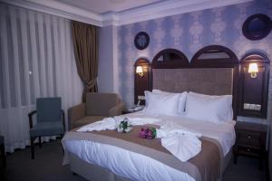 a hotel room with a large bed with flowers on it at Golden Pen Hotel in Istanbul