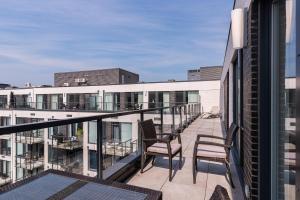 a balcony with chairs and tables on a building at Le Se7t Penthouses in Montréal