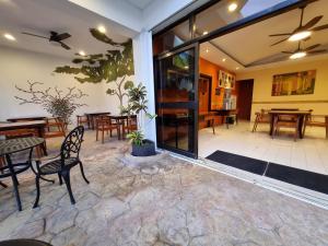 a patio with a table and chairs and a dining room at Hotel Plaza Cozumel in Cozumel