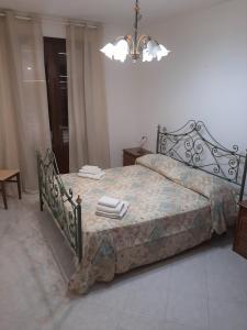 a bedroom with a bed with towels on it at L'Isola nel Mare in San Vito lo Capo