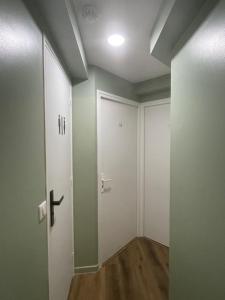an empty room with a door and a hallway at Hôtel P.L.M. in Cannes