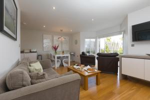 a living room with a couch and a table at 2 Four Seasons in St Ives