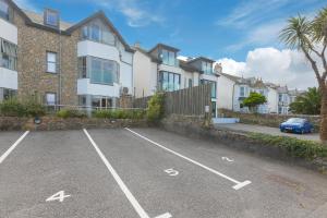 a parking lot in front of a row of houses at 2 Four Seasons in St Ives