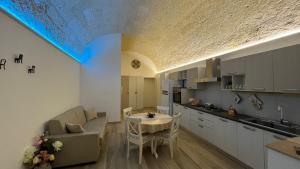 a kitchen and a living room with a table at Room 26 - B&B Altamura in Altamura
