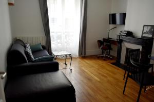 a living room with a couch and a fireplace at CdH Lantiez in Paris