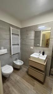 a bathroom with a sink and a toilet and a mirror at Room 26 - B&B Altamura in Altamura +13 photos