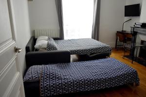 sala de estar con 2 camas y ventana en CdH Lantiez en París