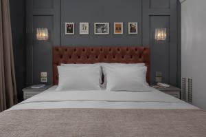 a bedroom with a large bed with white pillows at No 39 Svolou Suites in Thessaloniki