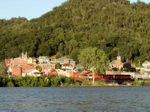 a town on the shore of a lake with a train at Bluffside cottage with gorgeous river views in Fountain City
