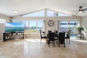 a dining room with a table and a large window at Villa Thunderbird View, Cape Coral in Cape Coral