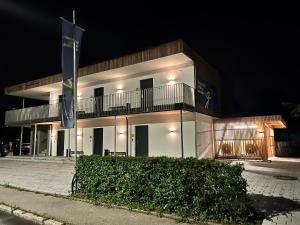 a building with two flags in front of it at night at DAS GEORG Gästehaus in Epfendorf 