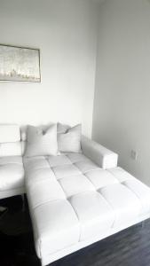 a white couch sitting in a living room at DTLA Luxury Condo with Pool, Gym, Work Pods & Conference Room in Los Angeles