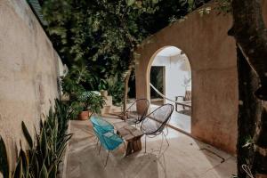 um pátio com 2 cadeiras e uma mesa num arco em Casa La Sultana: Amazing new house with pool em Valladolid