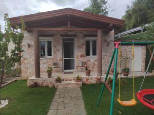 a small house with a porch and a swing at Villa Stella in Florina