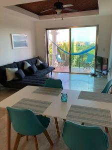 a living room with a couch and a table and chairs at Villa Talia, Relax, beach & Nature in Puerto Aventuras