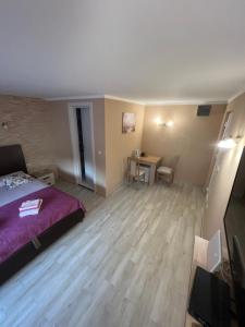 a bedroom with a bed and a desk and a table at Studio Elena in Tivat