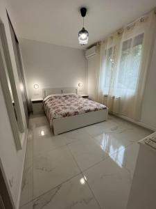 a bedroom with a bed in a white room at Appartement Marseille - Le Canet in Marseille