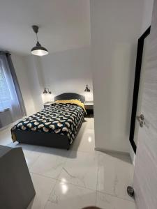 a bedroom with a bed in a white room at Appartement Marseille - Le Canet in Marseille