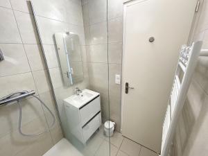 a bathroom with a toilet and a sink and a shower at Appartement spacieux près de la plage et commerces, 4 couchages - FR-1-361-433 in Donville-les-Bains +18 photos